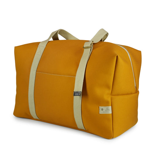 Maggie Felisi travel bag made of double mustard-colored technical canvas and adjustable beige cotton handles
